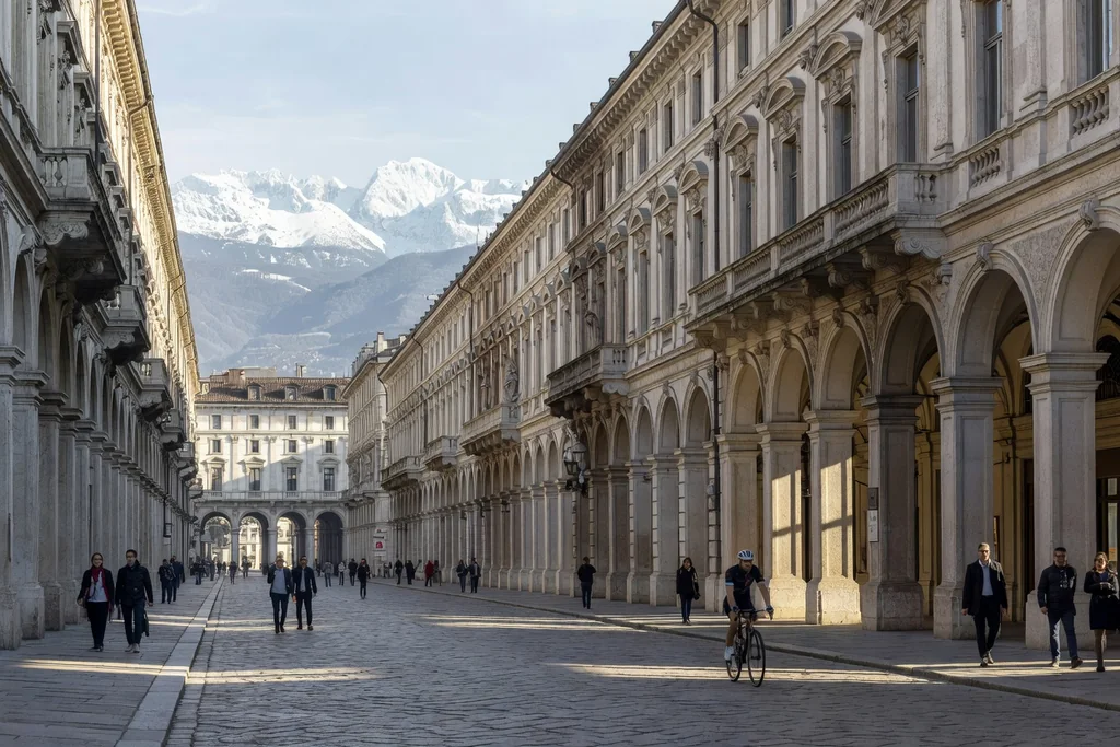 Turin arcaded boulevard with elegant baroque facades and alpine hills in the distance