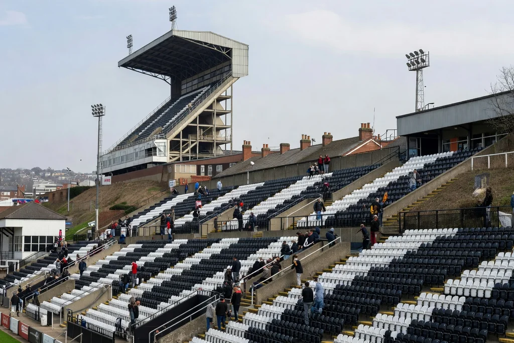 City-centre English football ground built on a hillside, one very tall main stand dominating the skyline